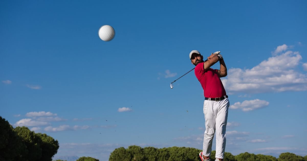 A golfer slicing the ball during a golf shot.